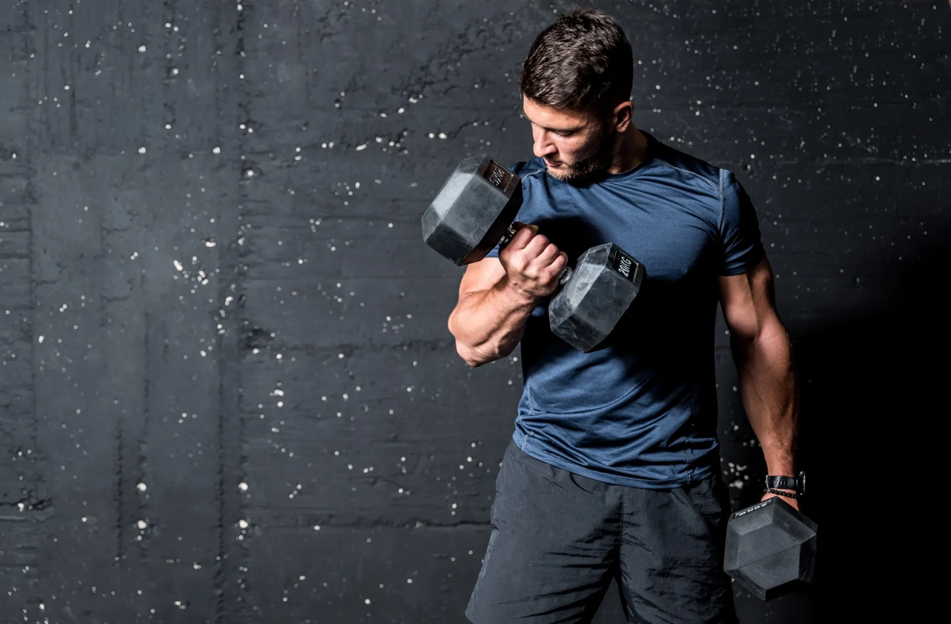 Fit man with dumbbells representing vitality restored through hormone therapy at Rewind Anti-Aging Miami