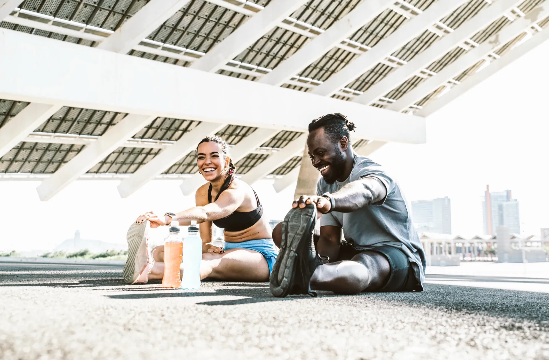 Active couple stretching outdoors representing wellness programs at Rewind Anti-Aging Miami
