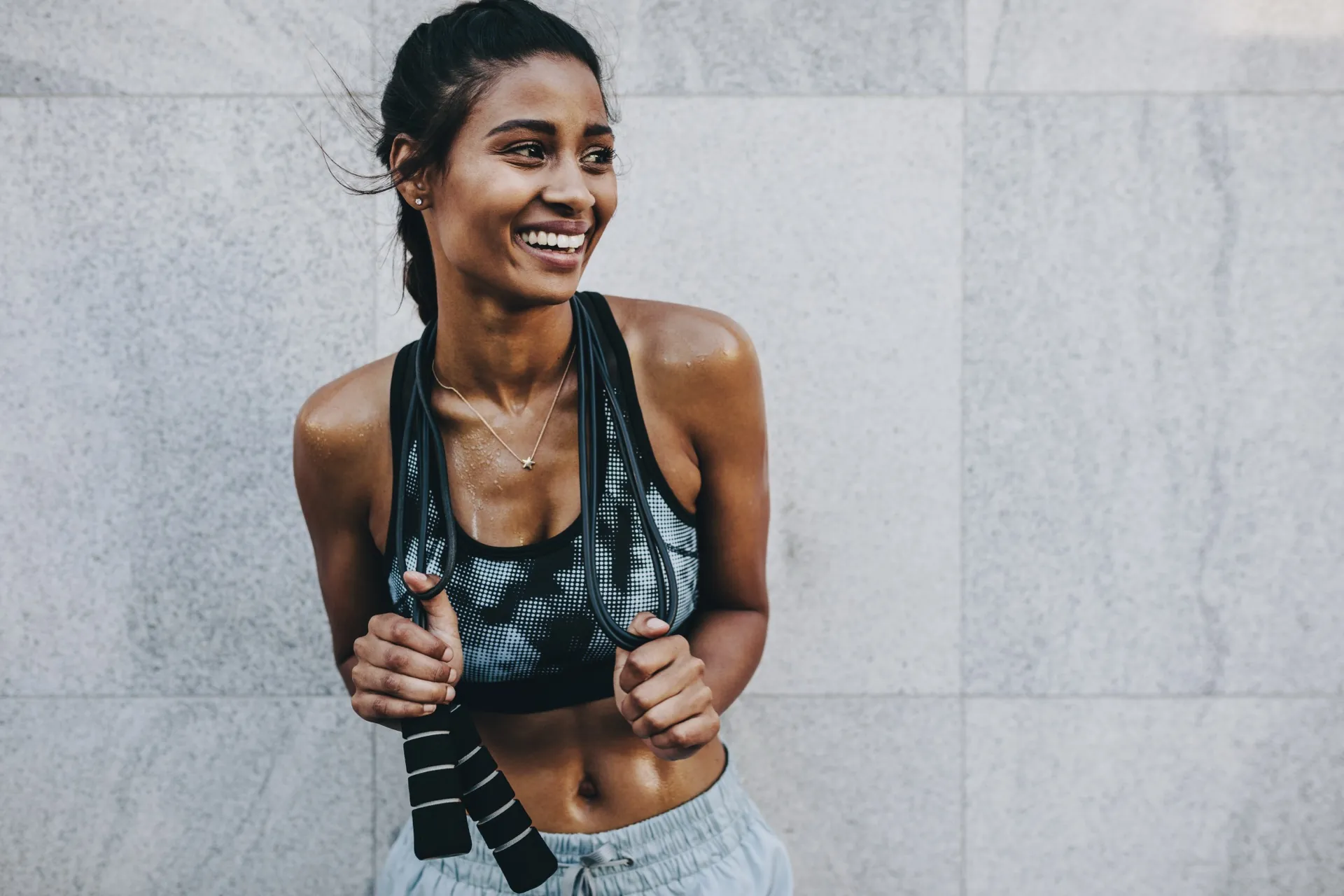 Confident fit woman representing female sexual wellness with topical arousal therapy at Rewind Anti-Aging Miami