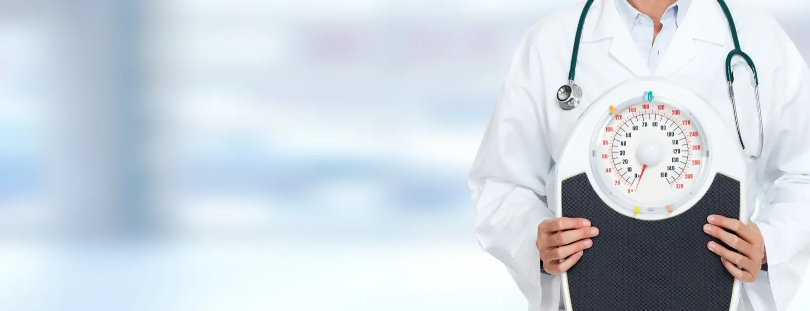 Doctor with weight scale for physician-supervised medical weight loss at Rewind Anti-Aging Miami