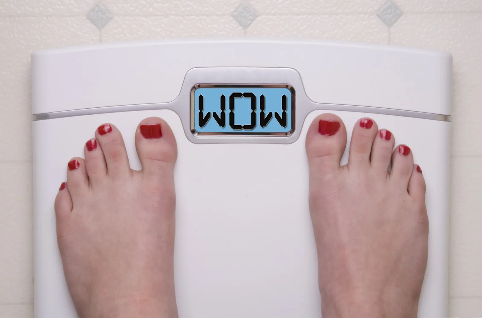 Person excited by weight loss results on a scale representing semaglutide therapy success at Rewind Anti-Aging Miami